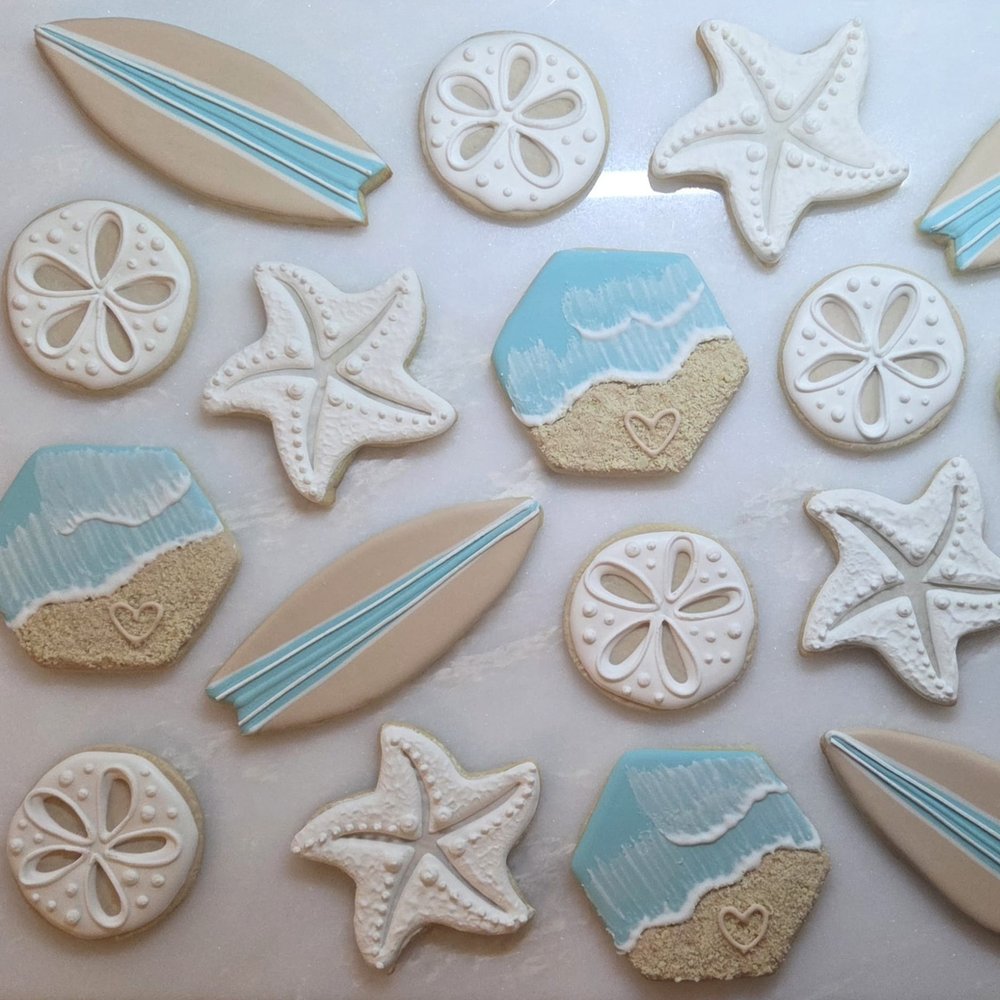 Beach wedding cookies with surfboards, starfish, sand dollars and waves